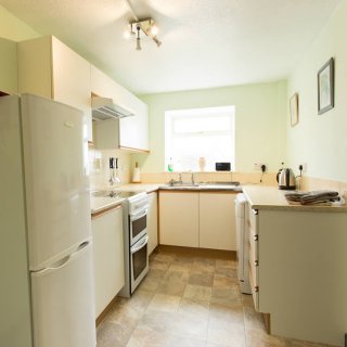 The well appointed kitchen has a cooker, microwave & dishwasher