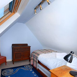 The attic room, reached through the single upstairs bedroom, can have twin beds.