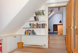 The attic is room reached through the single upstairs bedroom.