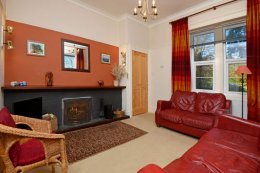 The sitting room has large windows with great views (& now has a wooden floor)