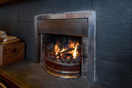 The sitting room features an open fire for cozy evenings in.