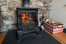 The holiday cottage features a cozy wood-burning stove.