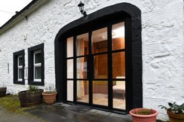 The Mews holiday cottage has un-fenced outside space with furniture.