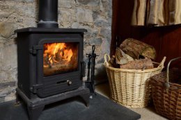 The holiday cottage features a cozy wood-burning stove.