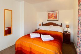 The double bedroom has windows on two sides.