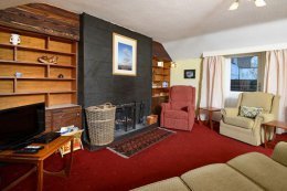 The sitting area features an open fire for cozy evenings in.