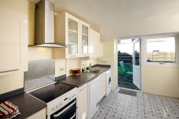 The well equipped kitchen opens directly onto the enclosed rear garden.