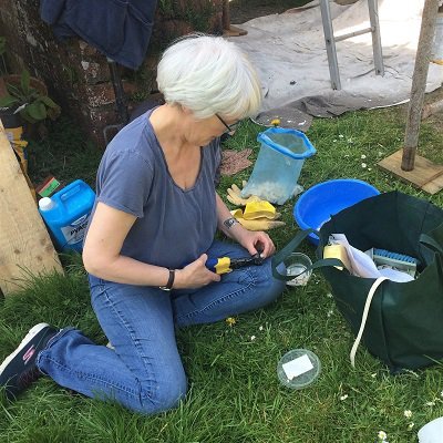 Helen Miles cutting extra tiles for the garden mosaic
